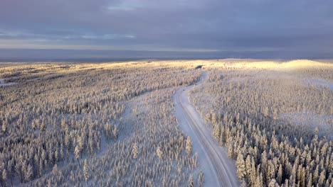 Panoramic-view-of-winter-road-covered-in-snow,-Surrounded-by-forest,-Sweden