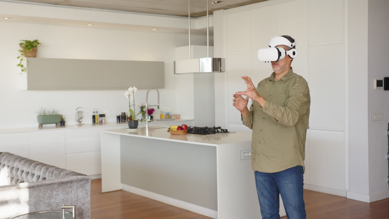 Using VR headset, man interacting with virtual environment in modern kitchen, at home, copy space
