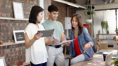 discussing interior design ideas, multiracial team using tablet and samples in modern office