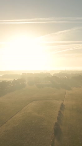 sunrise over misty farmlands