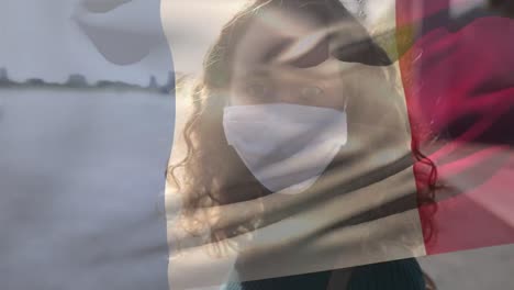 French-flag-waving-against-woman-wearing-face-mask