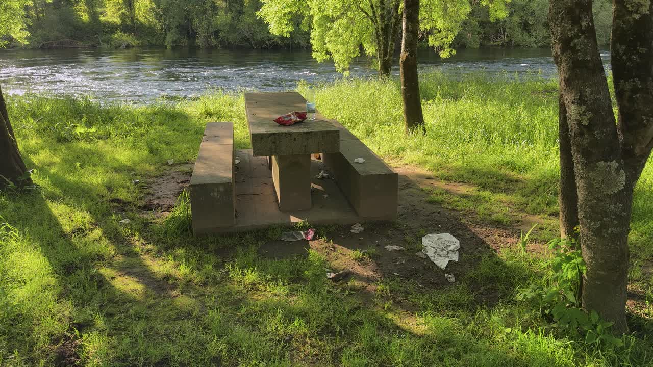 A beautiful but very dirty barbecue area remains after the people have left.