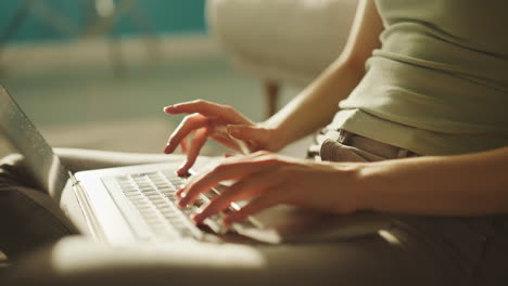 woman's hands typing on laptop