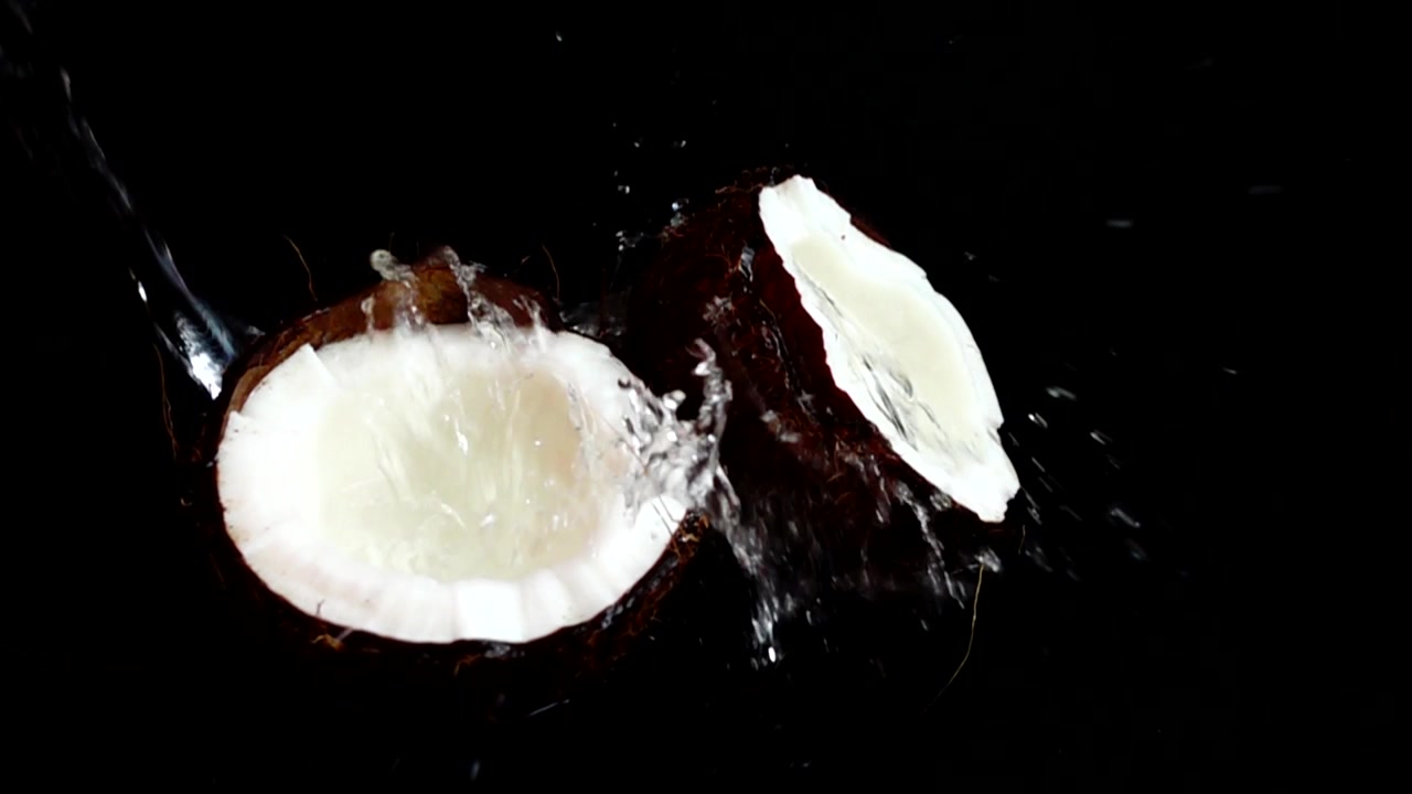 Ripe and juicy coconut on a black background.