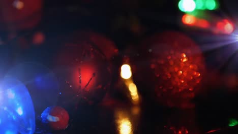 animation of red baubles christmas decoration with glowing lights