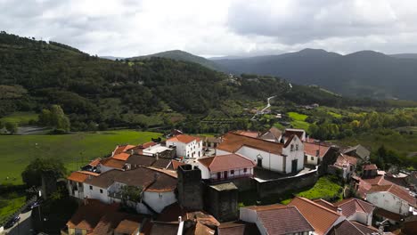 aerial orbit around castle town in vinhais, braganza, portugal in lush green valley