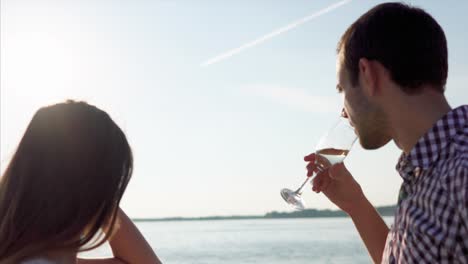 couple celebrating by the river with champagne