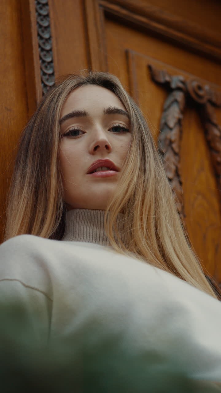 Woman leaning against a wooden door