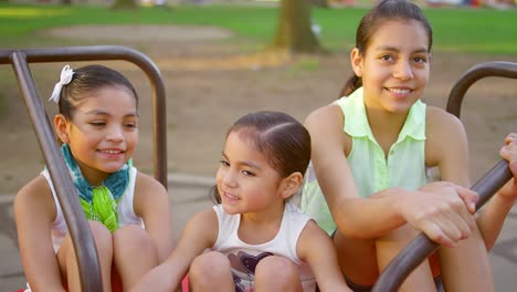 young girls sitting on a merry-go-round