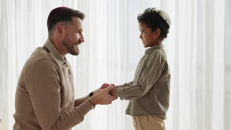 Man,-child-and-talking-religion-in-home-for-Jewish