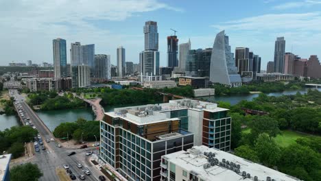 aerial rising shot reveals colorado river and austin, texas skyline