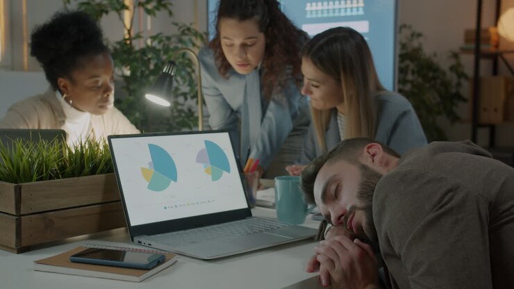 Team Meeting at Night With Exhausted Employee