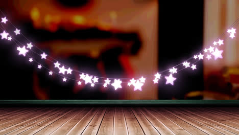 glowing pink star shaped fairy light decoration hanging over wooden plank