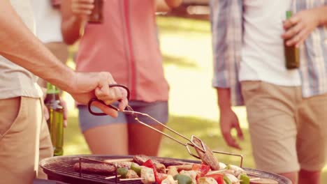 happy group of friend doing barbecue in the park