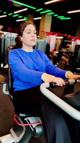 young woman doing cardio training on stationary bike