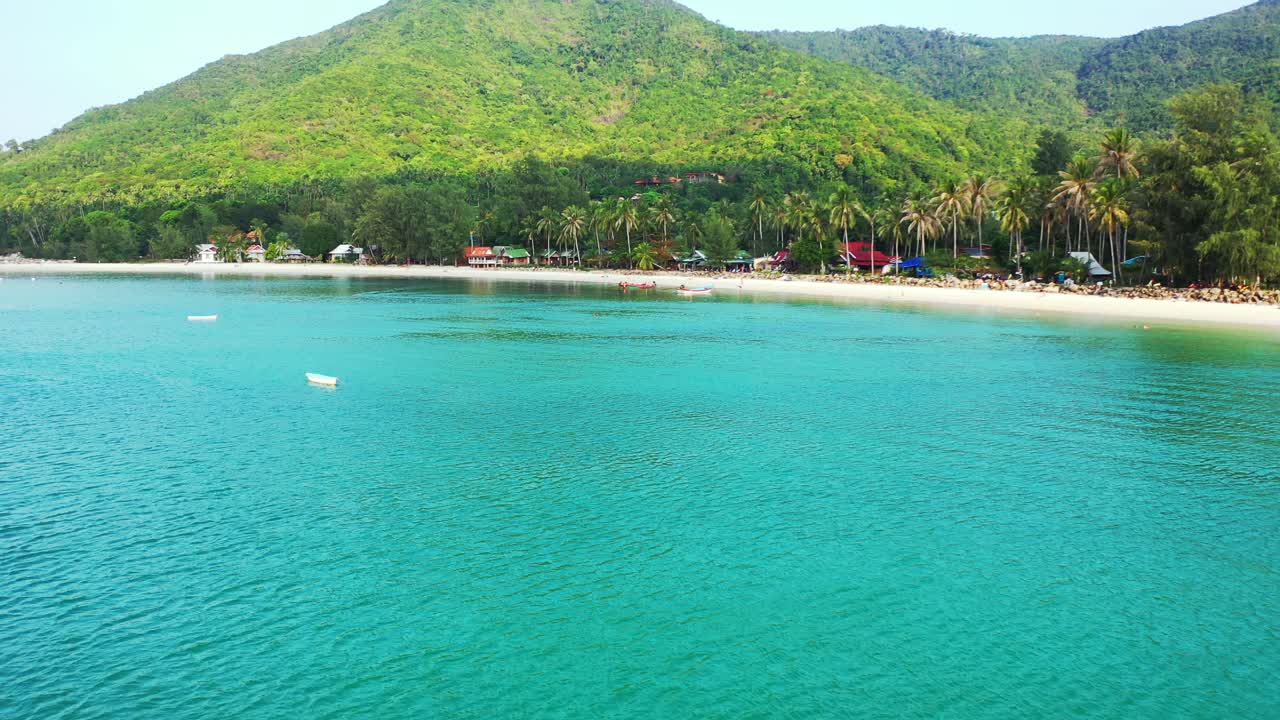 Small boats surrounding sandy beach on the north coast of Thailand