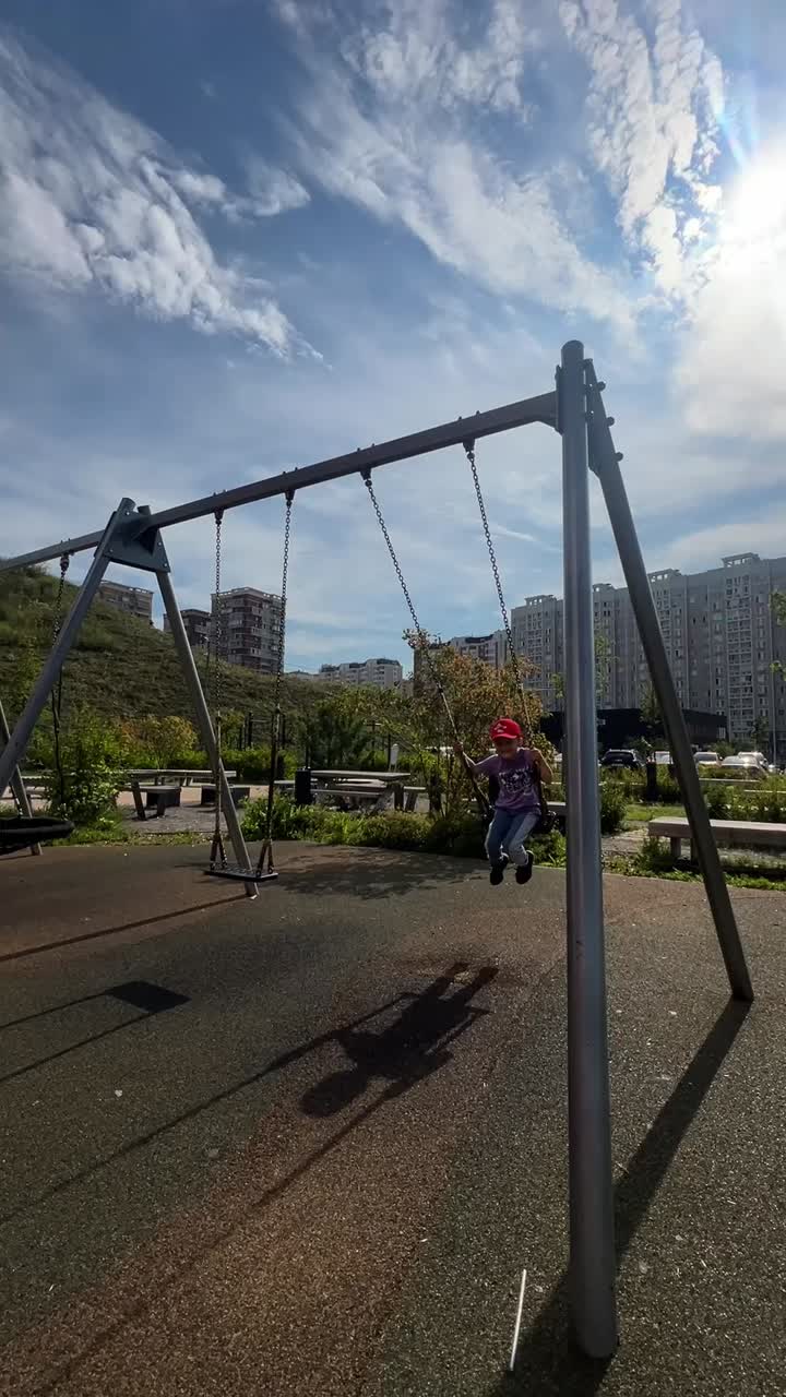 Boy on a swing in a playground