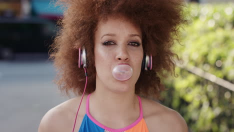 Slow-Motion-Portrait-of-funky-mixed-race-woman-listening-to-music-blowing-bubblegum-in-city