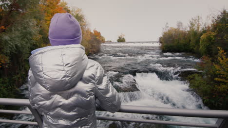 the child looks at the picturesque tributary of the niagara river near niagara falls. travel in the usa