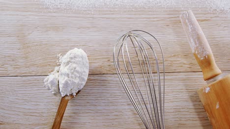 Kitchen-utensils-and-flour-on-wooden-table-4k