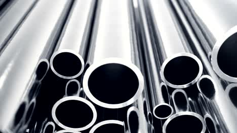 metal pipes stacked. heap of shiny metal steel pipes with selective focus effect.