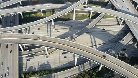 Aerial-view-over-major-Los-Angeles-highway-with-busy-rush-hour-traffic-travelling-interchange-roads