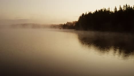 foggy sunrise by the lake with nice reflection of the surrounding islands in a nice summer morning