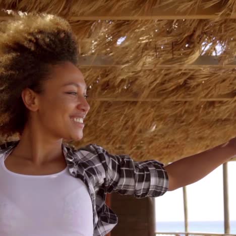 Young-Woman-Admiring-Ocean-View-on-Windy-Day