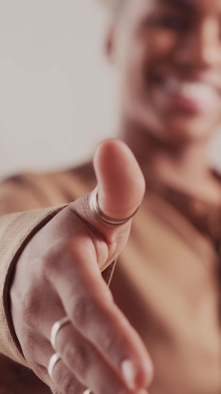 Smiling african american woman offering a handshake in closeup view
