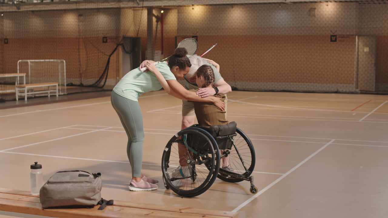 Coach and Athletes Hugging Before Game