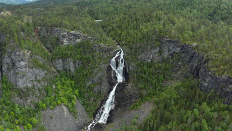 aerial view around the gloppefossen falls, in norway - circling, tilt, drone shot