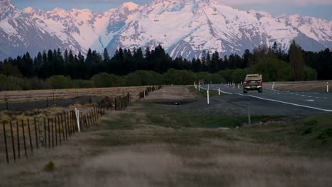 Pick-up-truck-driving-towards-majestic-snow-capped-mountains