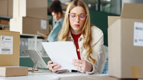 woman prepares packages for shipping in her small business