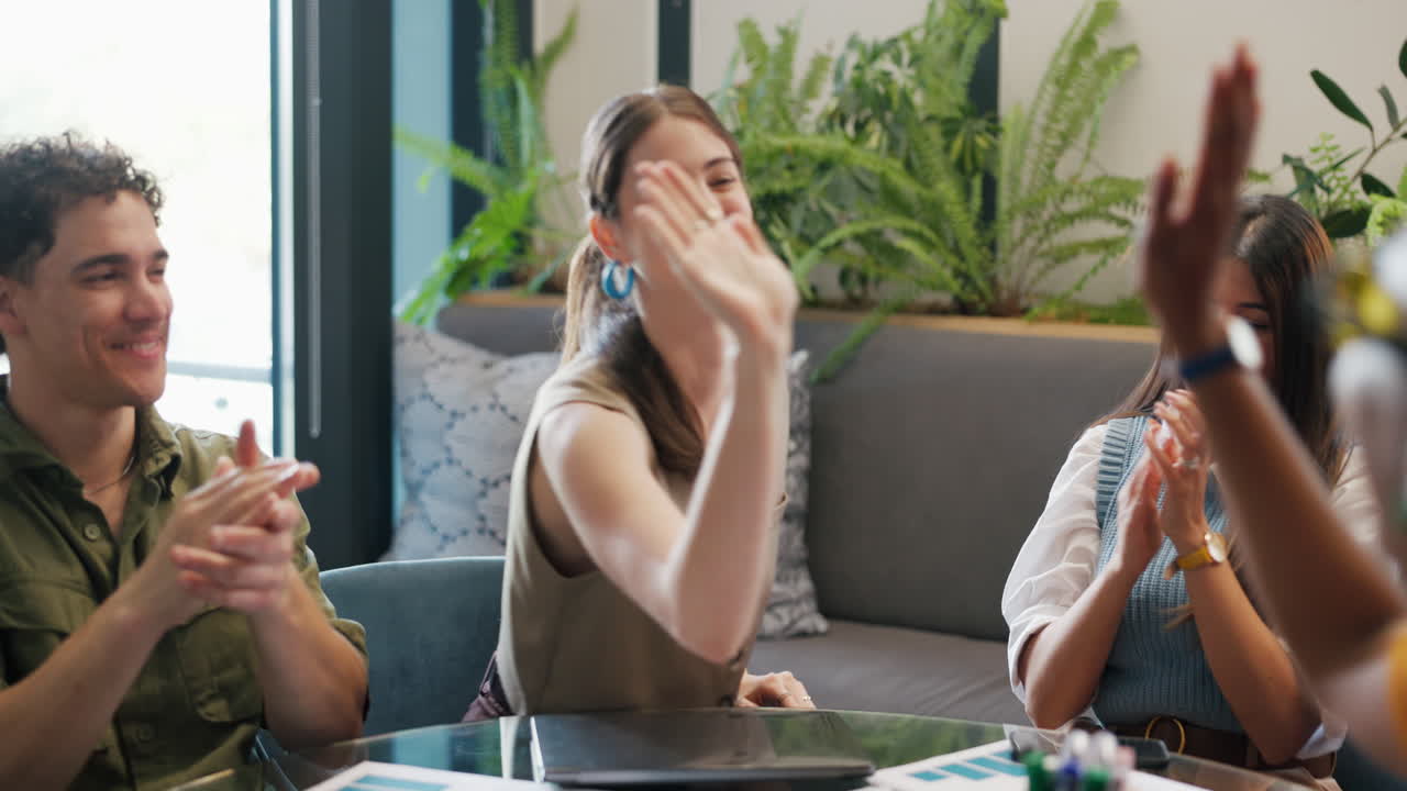 Young Diverse Colleagues Clapping and High-Fiving in Office Meeting