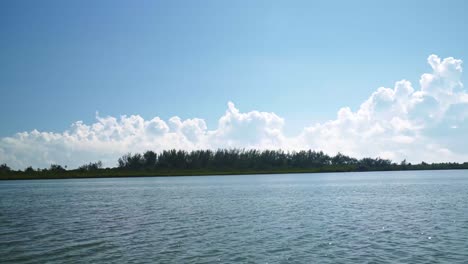 Driving-on-a-speedboat-on-a-huge-river-surrounded-by-a-mangrove-forest-inside-of-the-tropical-ecological-nature-reserve-Sian-Ka'an-in-Riviera-Maya,-Mexico-near-Tulum