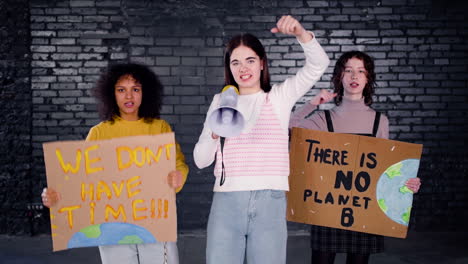 young female environmental activists protesting against climate change inaction