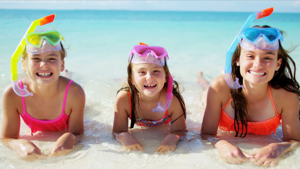 Portrait of Caucasian girls on beach going snorkeling