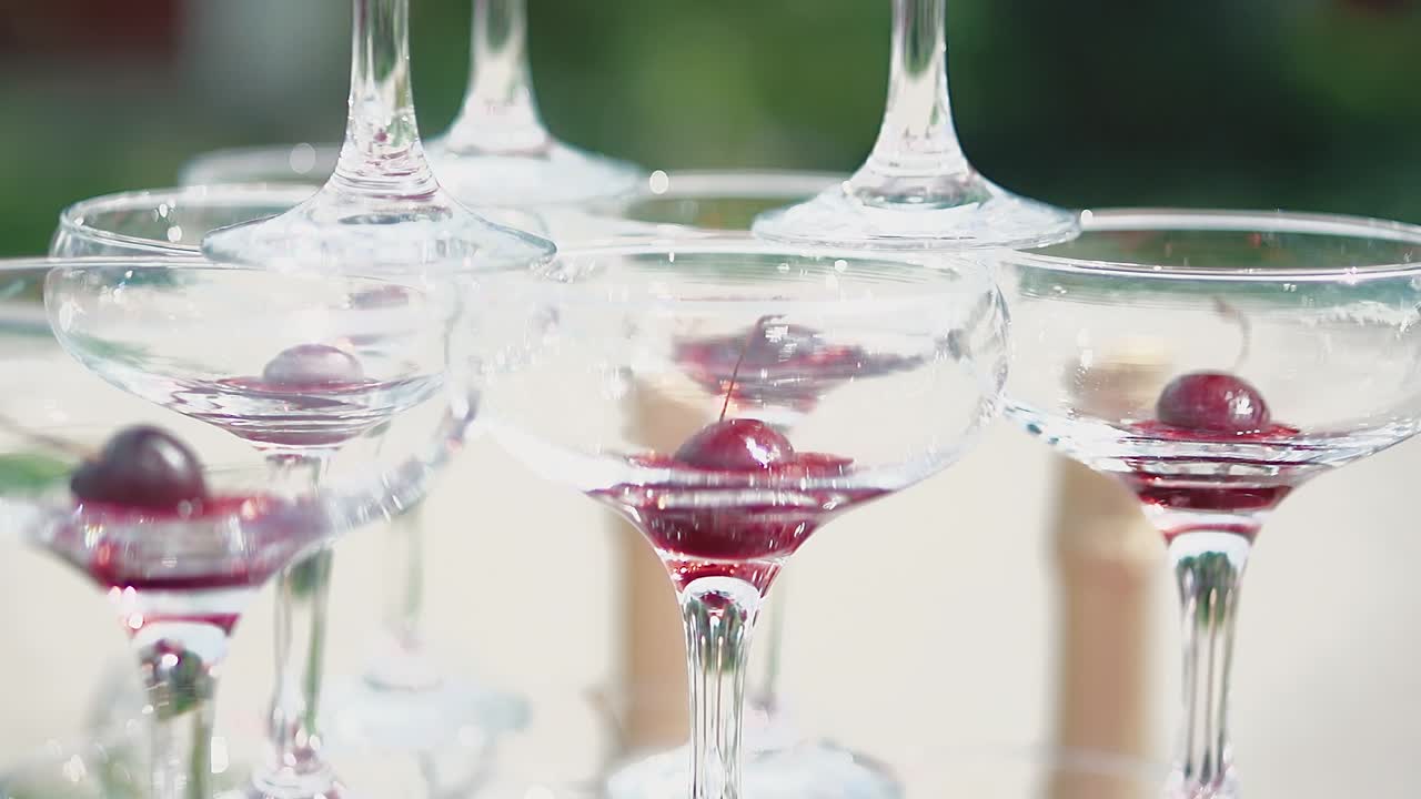 Pyramide af glas, hvor der er et kirsebær i hvert glas.