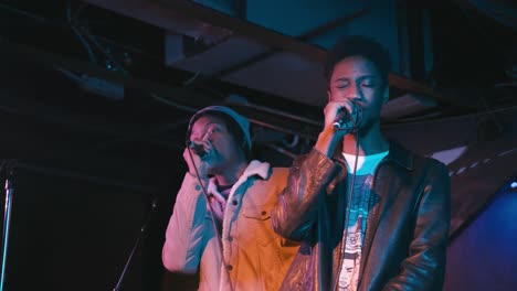 atlanta, ga - december 15, 2018: a rising star in the southeastern rap scene, boregard, performs in a hip-hop duo at a lively concert in an underground urban nightclub popular with millennials.