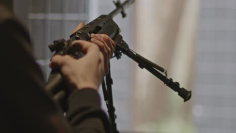 shooter closing bolt of ruger mini-14 rifle in slow motion and loading the weapon