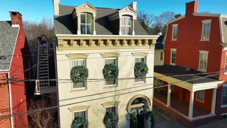 aerial rising shot of city house decorated for christmas