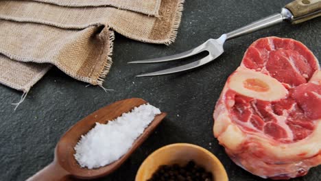 sirloin chop and ingredients on concrete background