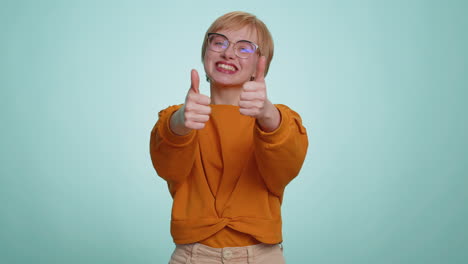 young woman raises thumbs up agrees or gives positive reply recommends advertisement likes good idea