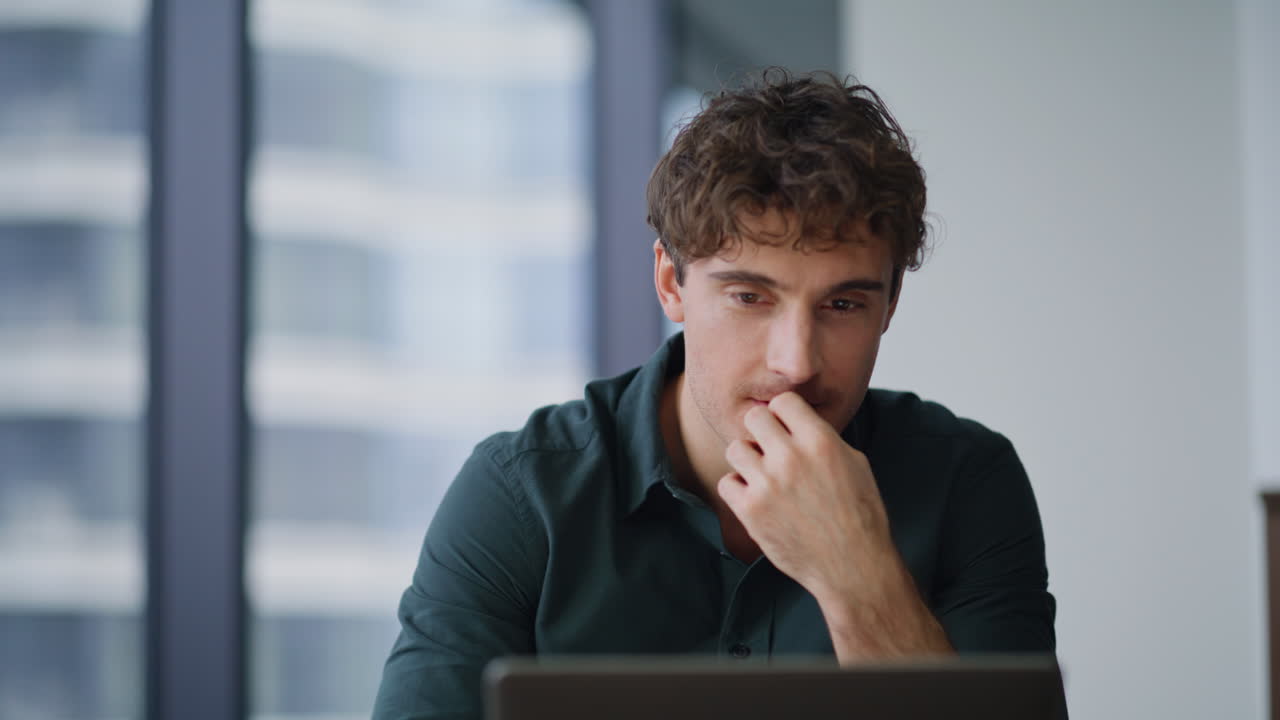 Enthusiastic professional working laptop at corporate office interior closeup