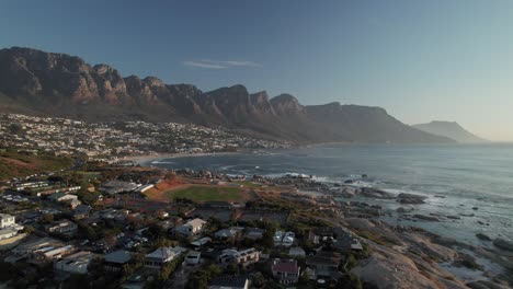 camps bay beach with twelve apostles ridge and table mountain national park in cape town, south africa