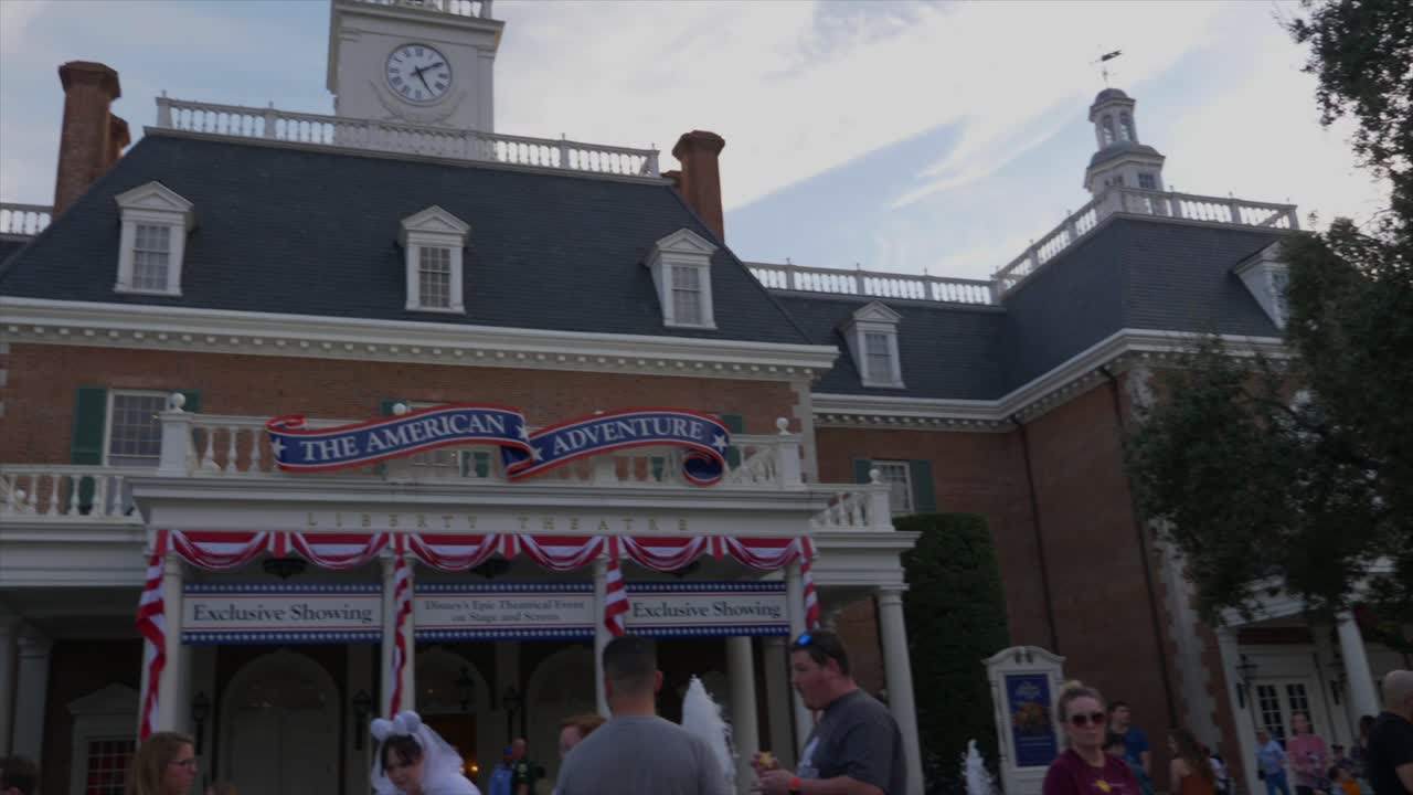 People walking past American Adventure in Disney World's Epcot America Pavilion