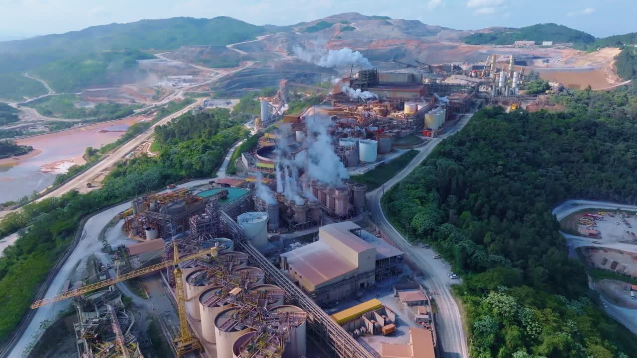 Large industrial facility in the mountains, concept of air pollution, aerial