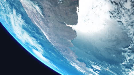 argentina sudamérica desde el espacio con la tierra girando lentamente con vista desde la órbita con nubes dinámicas atmósfera marina y fuerte reflejo del sol en el mar océano