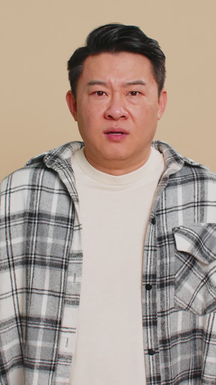 Scared fearful depressed asian man suffering phobia anxiety disorder expresses fear stress panic