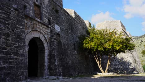 arched gate of medieval fortress with stone walls in mediterranean coast of albania